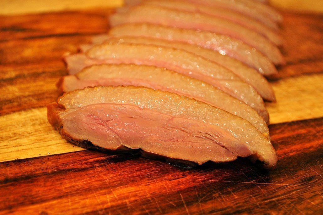Sliced duck ham on cutting board