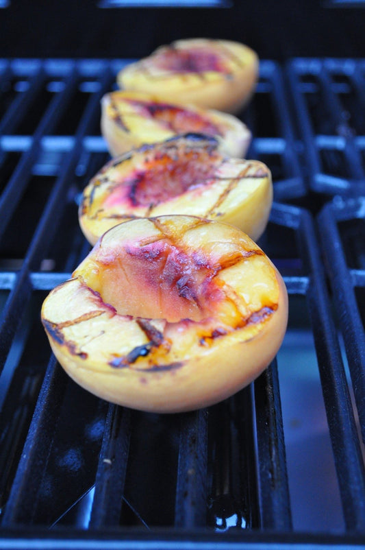 Grilled peaches on a BBQ
