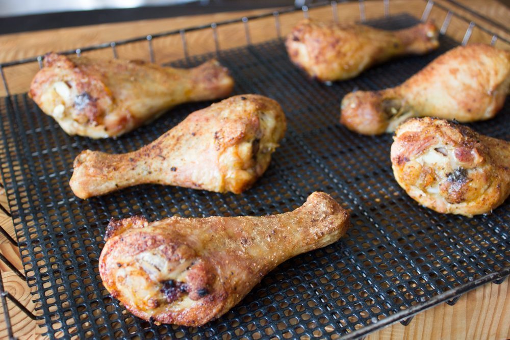 Smoked chicken drumsticks on magic mats and rack
