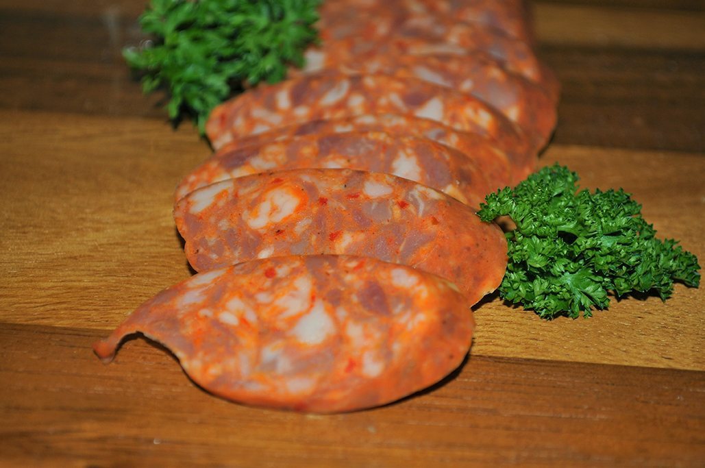 Sliced chorizo on cutting board