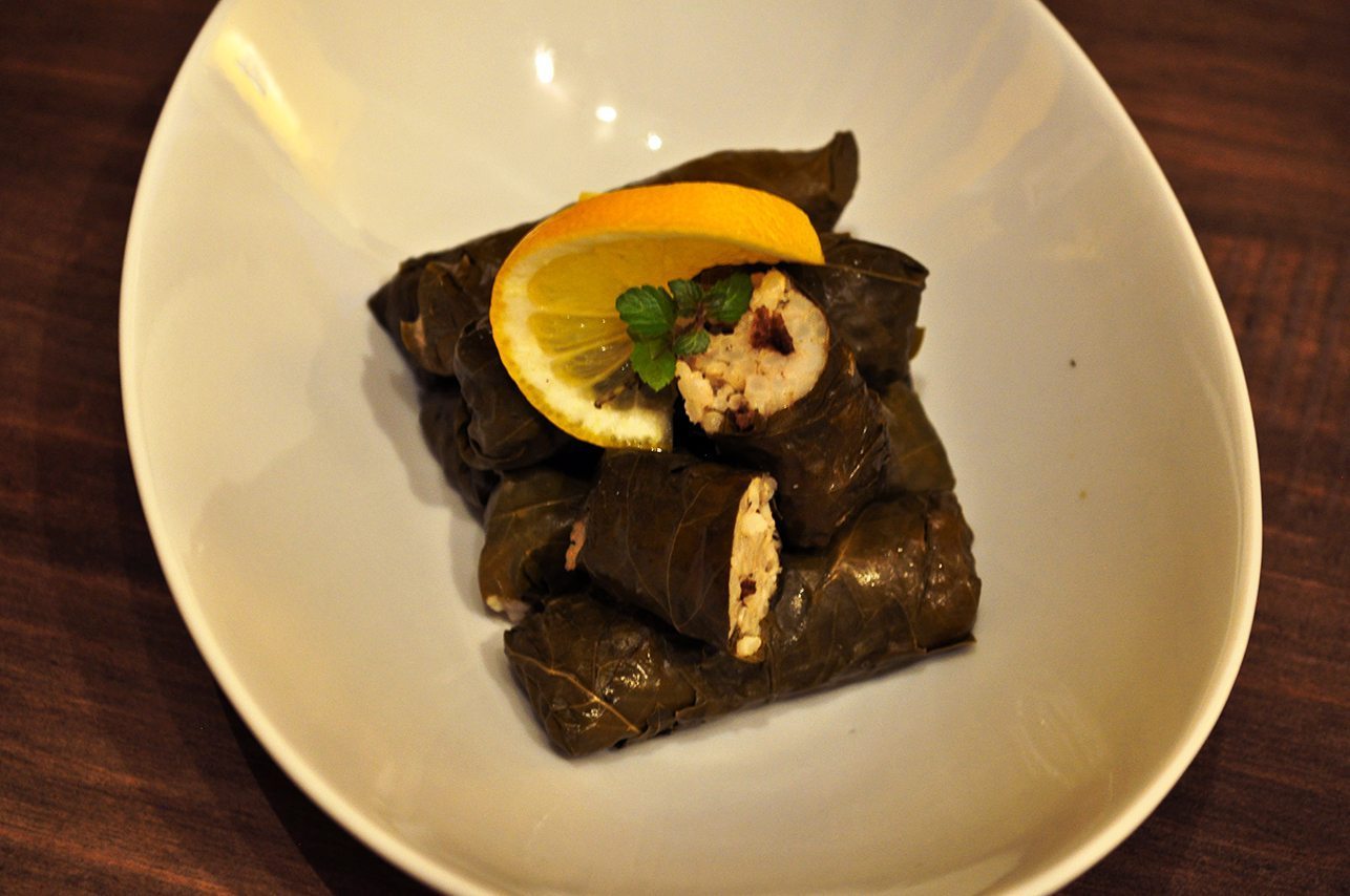 Lamb dolmades on a white plate