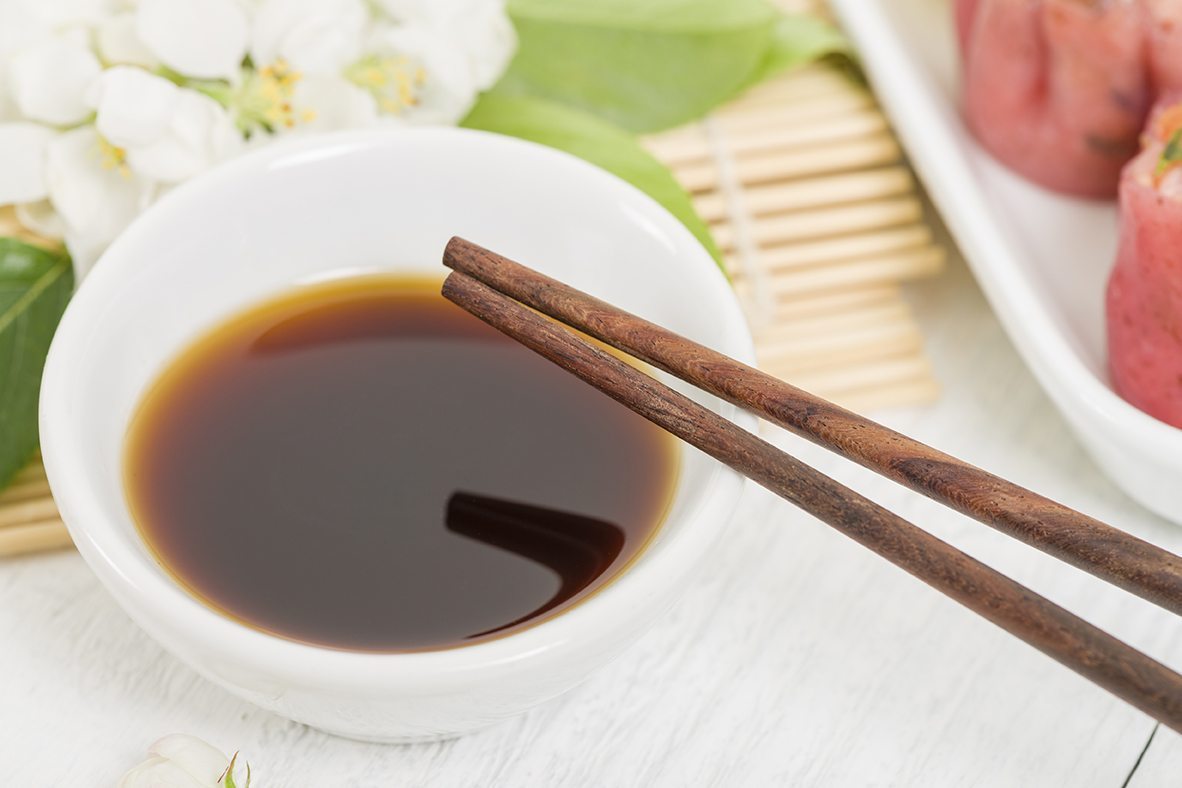 bowl of soy sauce with chopsticks